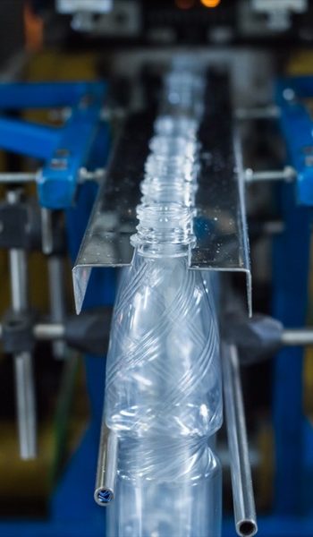 Drink water production line in industry. Bottle filling with water